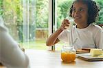 Girl drinking glass of milk at breakfast