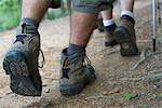 Hikers walking on path, close-up of feet