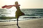 Woman at beach expressing sense of freedom