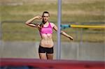 Young Female Athlete Performing High Jump