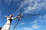 Young Female Archer Aiming at Target