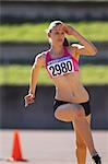 Young Female Athlete Performing High Jump