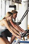 Young Couples Taking Physical Training on Exercise Bikes