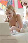 Young woman using laptop on couch