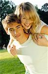 Young man carrying woman piggyback