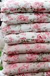 Stack of chair cushions with floral pattern