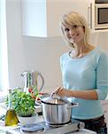 Young woman cooking in kitchen