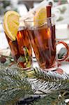 Two glasses with hot drinks and fir branches