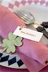 Place setting with four leaf clover and note