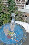 Carafe and glasses of water on garden table