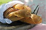 Three baguettes in wooden bowl