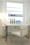 Standard lamp and desk with laptop at the window