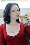 Young woman drinking Latte Macchiato