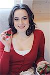 Young woman eating strawberries