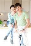 Young couple drinking red wine in kitchen