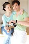 Young couple drinking red wine in kitchen