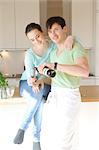 Young couple drinking red wine in kitchen