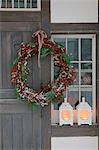 Front door with Christmas wreath and windlights