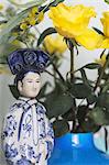 Yellow roses and Asian figurine