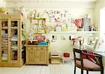 Room with cabinet, cuddly toys, storage boxes and chair at desk