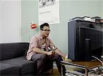 Man watching TV with beer and chips