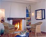 Living room with wicker chairs by the fireplace