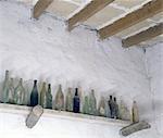 Empty glass bottles on shelf