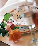 Place setting with wine and rose