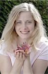 Smiling woman holding honeysuckle