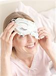 Woman in bed with sleeping mask