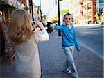 Girl Taking Photograph of Boy, Front Street, Toronto, Ontario, Canada