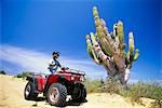 1990s WOMAN ON ATV NEXT TO CACTUS CABO SAN LUCAS MEXICO