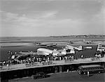 1950s CONSTELLATION FOUR MOTOR AIRPLANE FUELING AND LOADING PASSENGERS AT LAGUARDIA AIRPORT NEW YORK