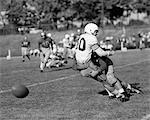 1950s COLLEGE FOOTBALL GAME ONE PLAYER TACKLING ANOTHER FUMBLE