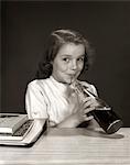 1950s - 1960s SMILING SCHOOL GIRL USING STRAW DRINKING CARBONATED BEVERAGE FROM BOTTLE