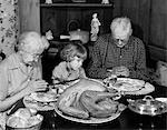 1950s - 1960s LITTLE GIRL LOOK AT TURKEY SITTING BETWEEN GRANDMOTHER GRANDFATHER SAYING GRACE AT TABLE