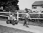 1950s BOY PULLING GROCERIES IN WAGON