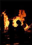 FIREMEN SILHOUETTED BY FIRE
