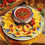 PLATE OF NACHOS WITH JALAPENO CHEESE AND BOWL SALSA