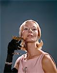 1960s FASHION ELEGANT BLOND WOMAN BLACK OPERA GLOVES BRACELET JEWELRY EARRINGS BROOCH HOLD GLASS OF CHAMPAGNE