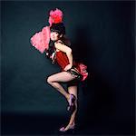 1960s WOMAN IN AMERICAN 1890s - 1900s WILD WEST SALOON SHOWGIRL STYLE COSTUME WITH PINK OSTRICH FEATHER FAN