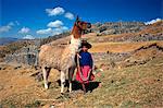 SACSAYHUAMAN, CUZCO, PERU INDIAN GIRL WITH LLAMA