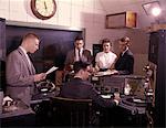 1960s GROUP OF 5 PEOPLE IN RADIO STATION CONTROL ROOM DISK JOCKEY DJ TURNTABLES BROADCASTING MEDIA COMMUNICATIONS