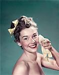 1940s - 1950s PORTRAIT SMILING TEEN GIRL WASHING FACE WITH WASHCLOTH