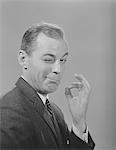 1950s - 1960s MAN WINKING EYE MAKING OKAY GESTURE SIGN WITH THUMB AND INDEX FINGER