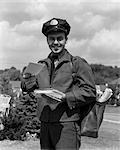 1950s MAN SMILING POSTMAN HOLDING OUT LETTER