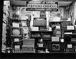 1940s WINDOW OF STORE SELLING RADIOS AND TELEVISIONS ADVERTISING A MILLION DOLLAR SALE