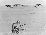 1930s RUINED FARM BEING OVERTAKEN BY ERODED TOPSOIL CREATING A DUST BOWL EFFECT IN AMERICA'S GREAT PLAINS NEAR ELDER COLORADO