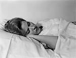 1960s WOMAN SLEEPING BED