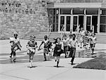 1960s BOYS AND GIRLS STUDENTS RUNNING OUT OF SCHOOL